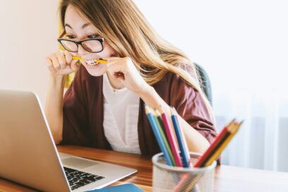 woman with a pencil in her mouth frustrated