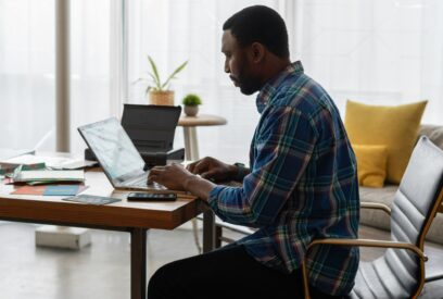 Manager sitting at a desk at his computer