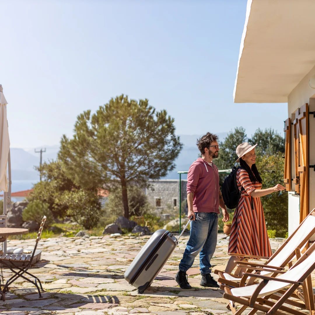 a couple about to enter through the door of their vacation house