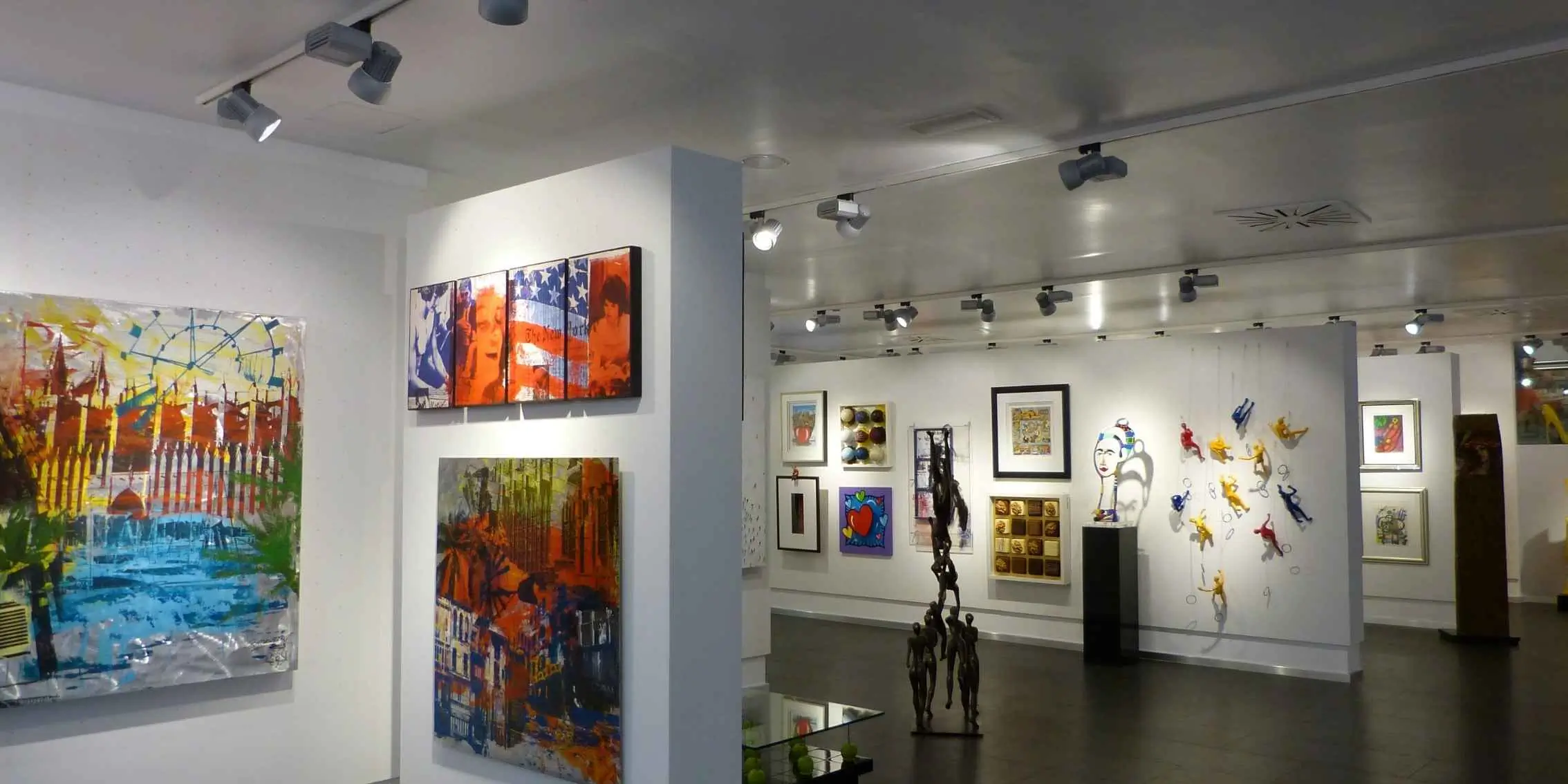 Modern art gallery with colorful abstract paintings, framed pop art, and
        contemporary sculptures on display