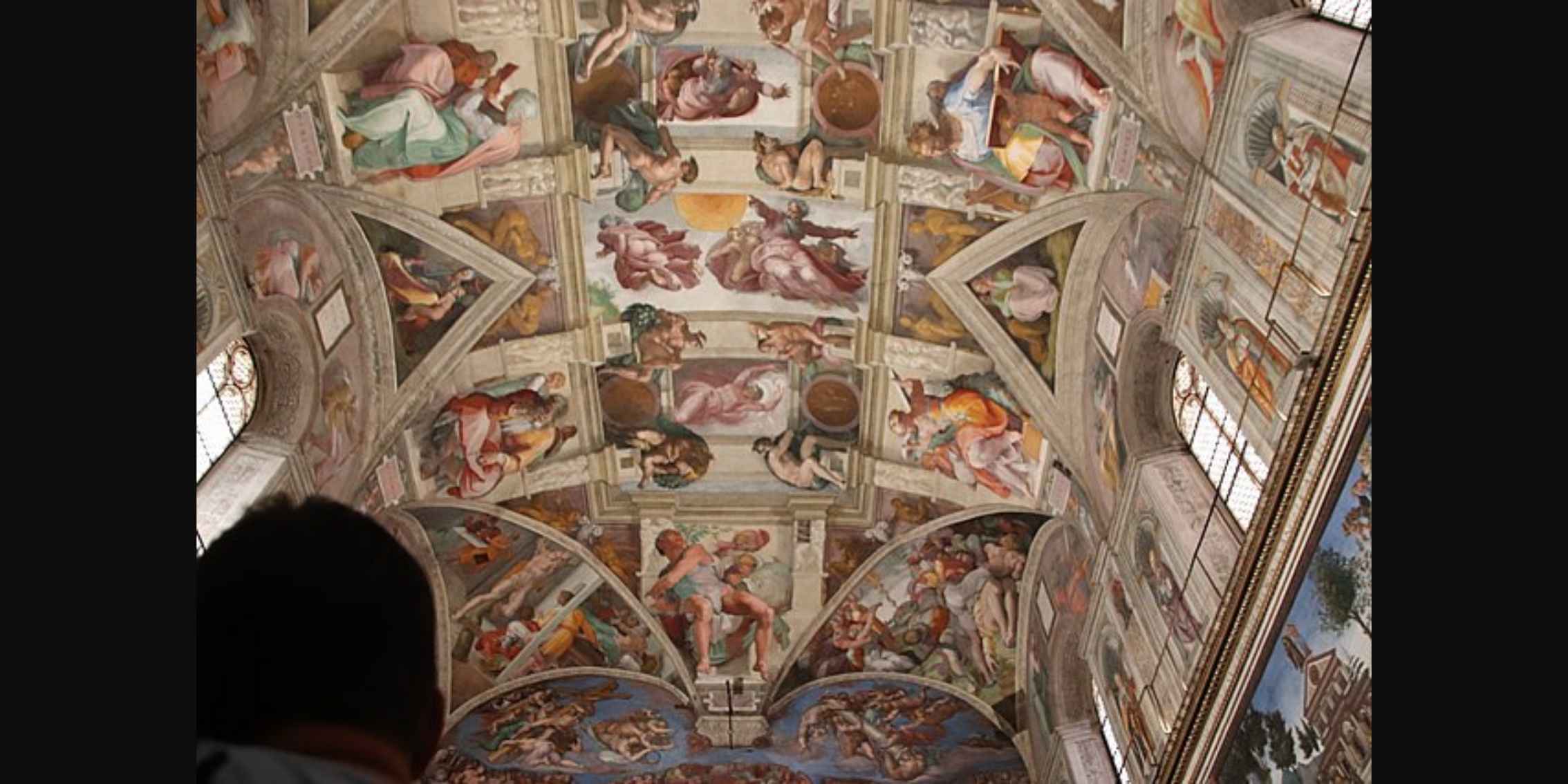 Michelangelo's Sistine Chapel
    Ceiling A person looking up at the ceiling of the Sistine Chapel, which is
    covered in Michelangelo's famous frescoes.