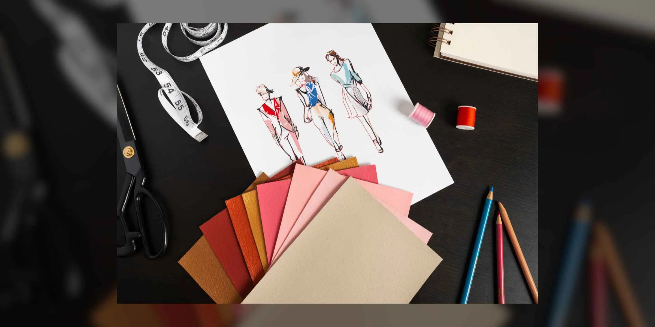 Fashion design sketch with fabric swatches, scissors, and coloured
                pencils