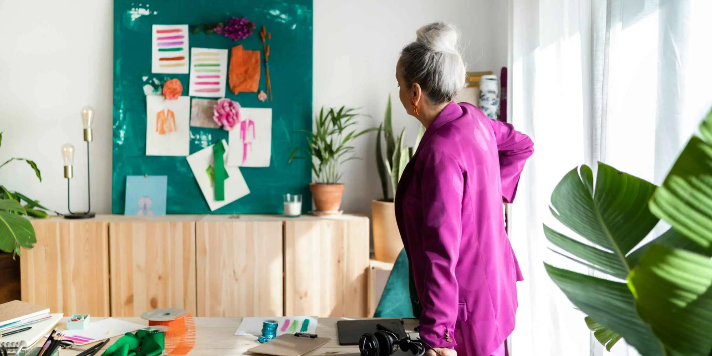 Woman with Mood Board on Colourful Wall