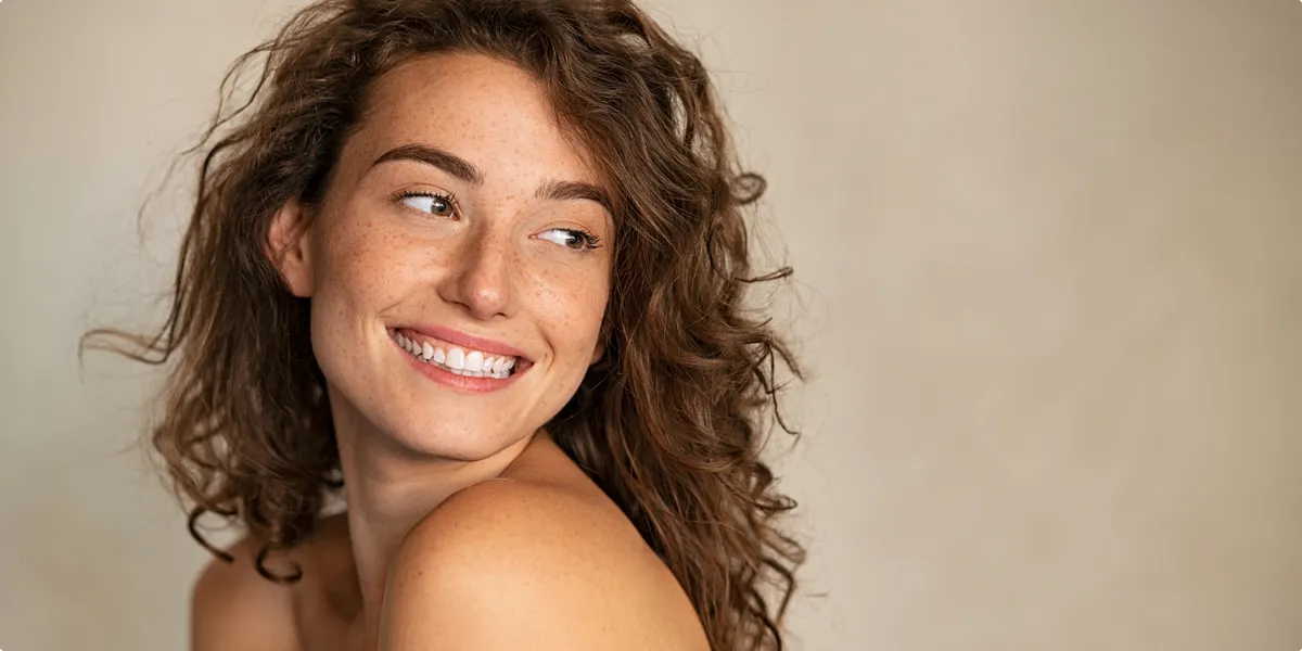 Smiling beauty woman with freckles looking away