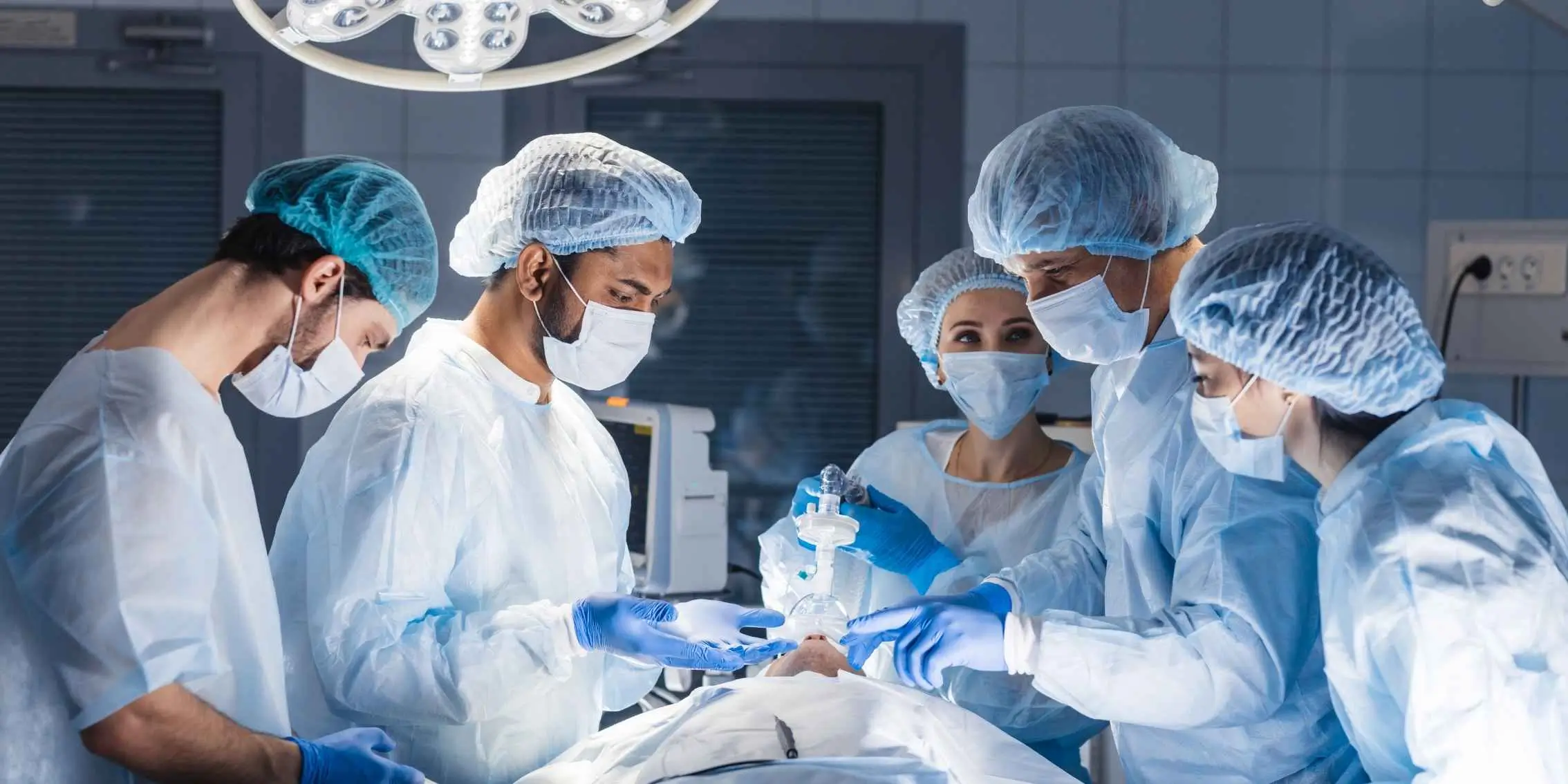 Team of surgeons and medical staff performing a procedure in a well-lit
        operating room