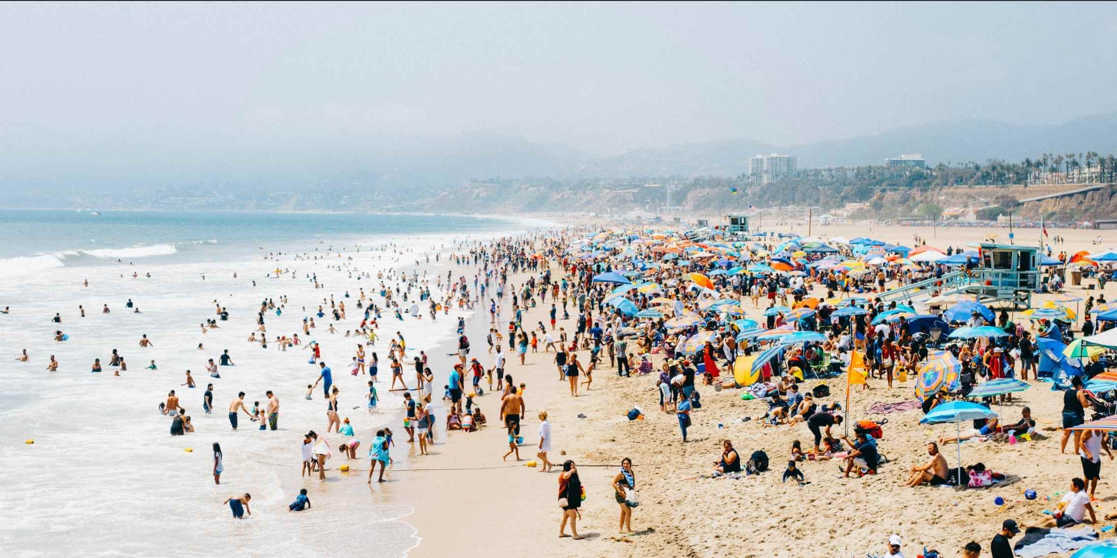 Why Photojournalism Matters Now More Than Ever – Capturing
Society Through Candid Moments A vibrant, high-angle photo of a crowded beach filled with people,
umbrellas, and lifeguard stations, capturing the essence of summer and public
spaces.