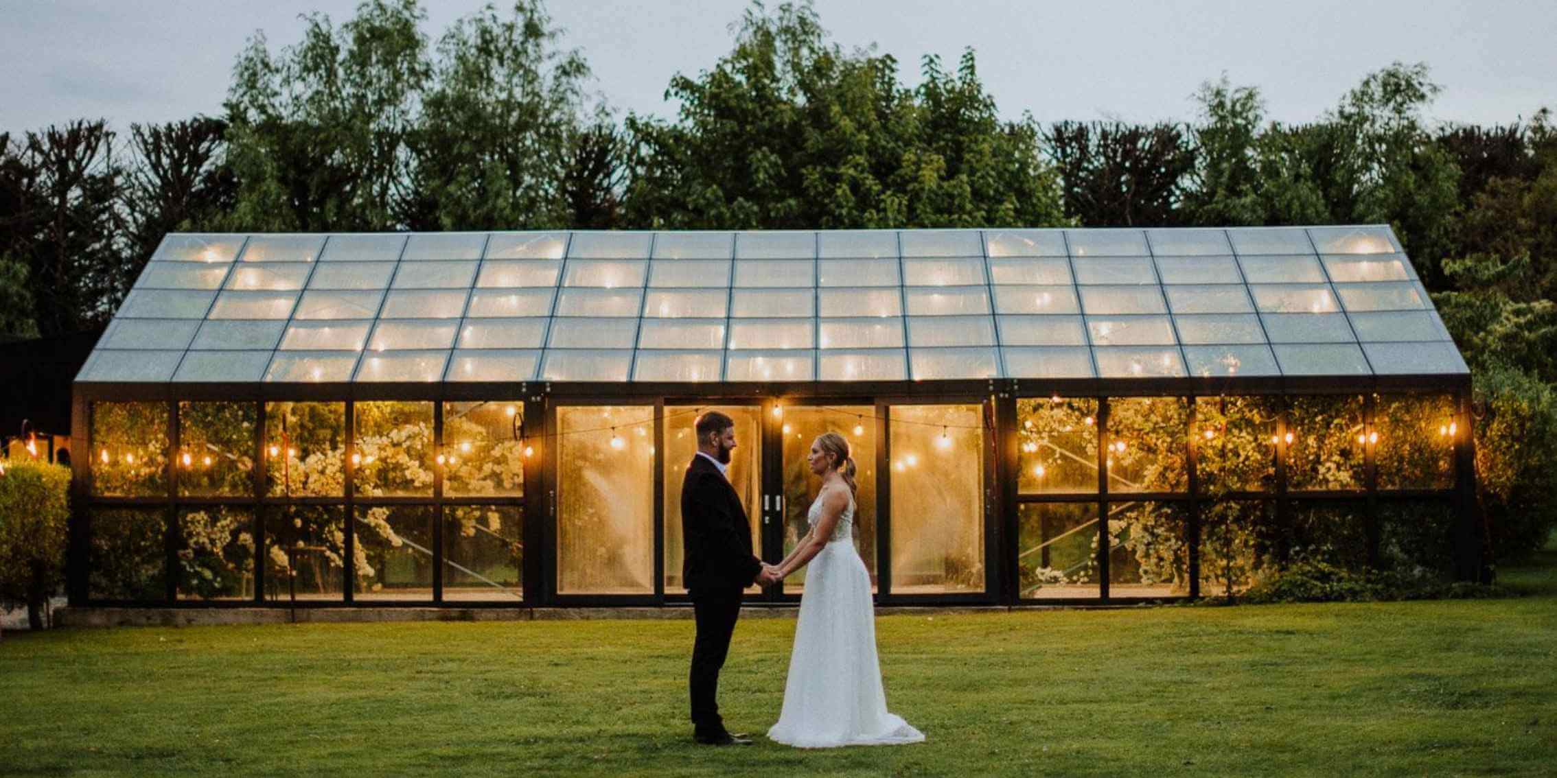 A Guide to Choosing Between sRGB and Adobe RGB – Managing
Colour and Contrast in Low-Light Photography A romantic evening wedding portrait of a couple standing in front
of a warmly lit glasshouse, showcasing dynamic range and colour balance in
photography.