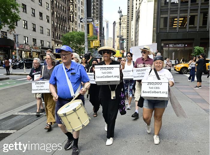 Marching to CBS with boxes of petition signatures.