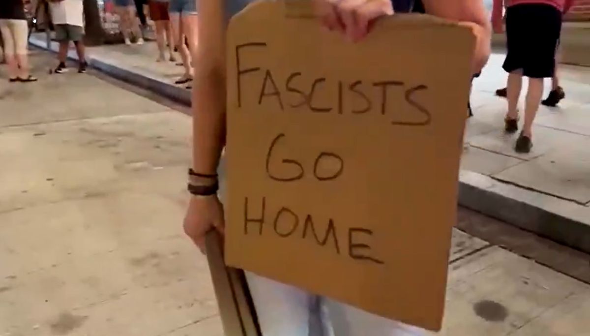 Protest sign: Fascists go home.