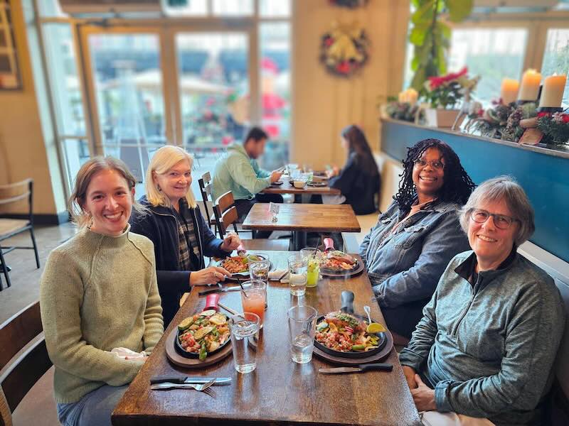 Three members of the Indivisible Georgia Coalition steering committee along with organizer Abby out to dinner