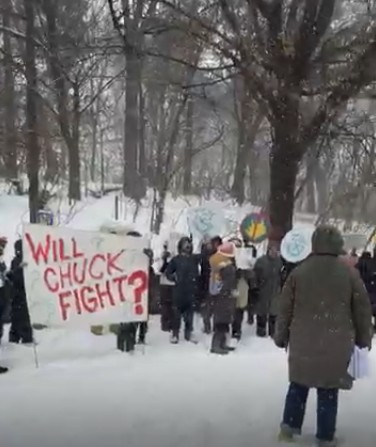 Members of Indivisible Brooklyn standing in a blizzard outside Schumer's home