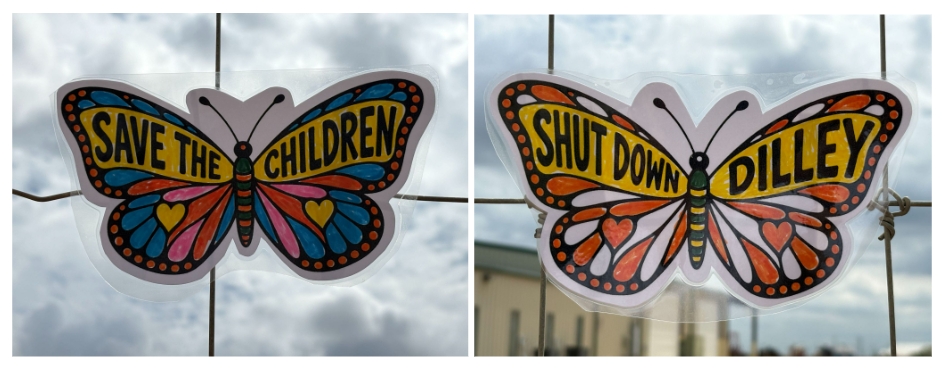 Colorful handmade butterflies outside of Dilley Detention Center that read Save the Children and Shut Down Dilley