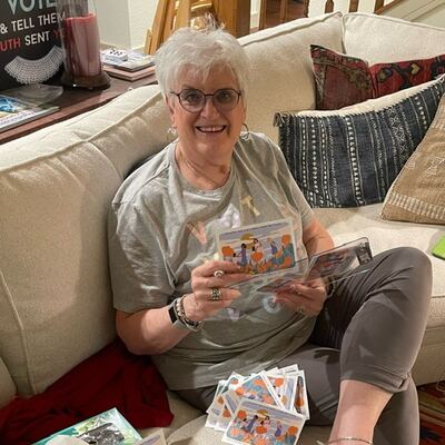 A MomsRising volunteer with handwritten postcards