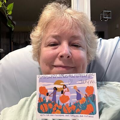 A MomsRising volunteer with handwritten postcards