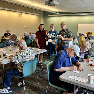 A MomsRising volunteer with handwritten postcards