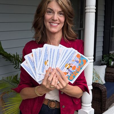 A MomsRising volunteer with handwritten postcards