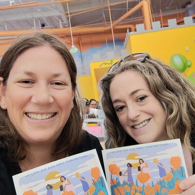 A MomsRising volunteer with handwritten postcards