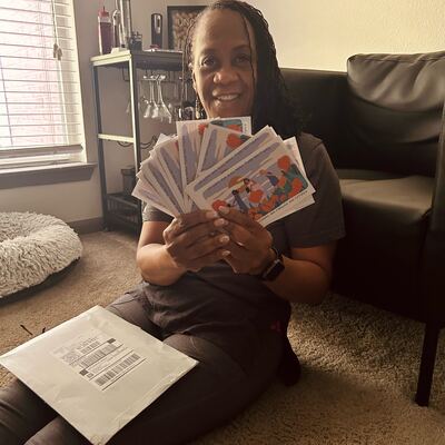 A MomsRising volunteer with handwritten postcards
