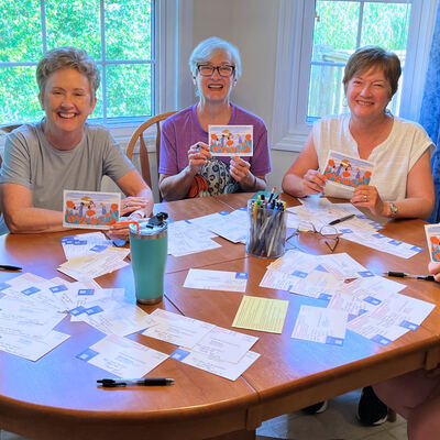 A MomsRising volunteer with handwritten postcards