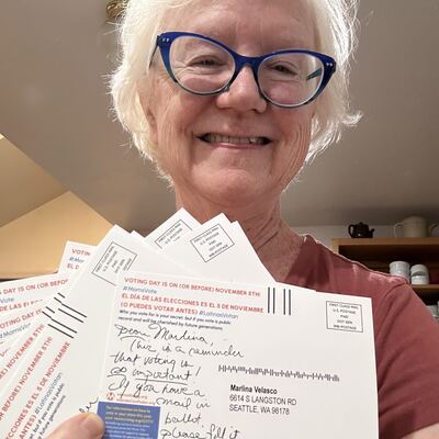 A MomsRising volunteer with handwritten postcards