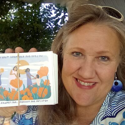 A MomsRising volunteer with handwritten postcards