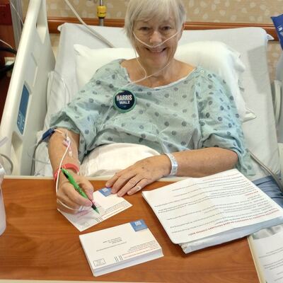 A MomsRising volunteer with handwritten postcards