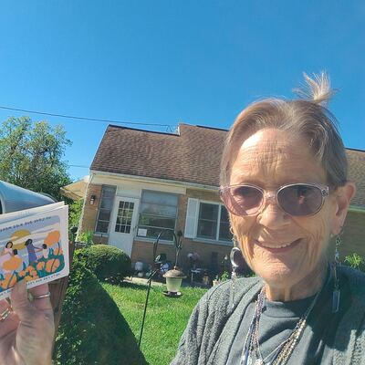 A MomsRising volunteer with handwritten postcards