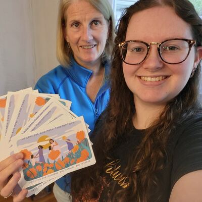 A MomsRising volunteer with handwritten postcards