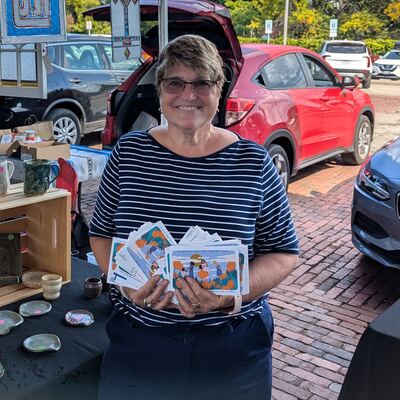 A MomsRising volunteer with handwritten postcards