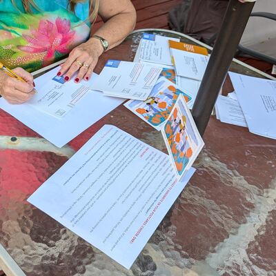 A MomsRising volunteer with handwritten postcards