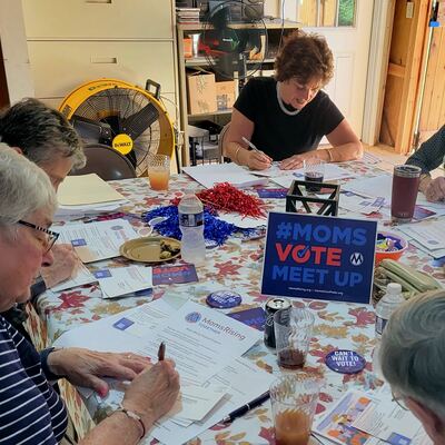 A MomsRising volunteer with handwritten postcards