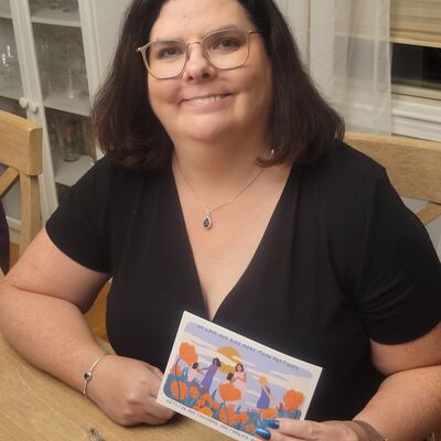A MomsRising volunteer with handwritten postcards