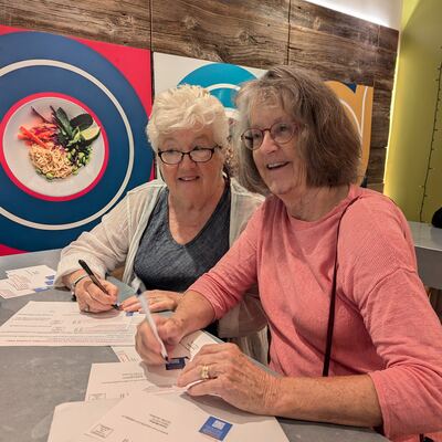A MomsRising volunteer with handwritten postcards