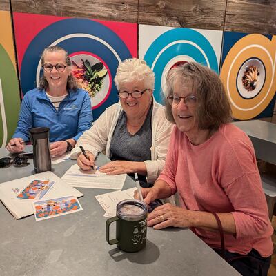 A MomsRising volunteer with handwritten postcards