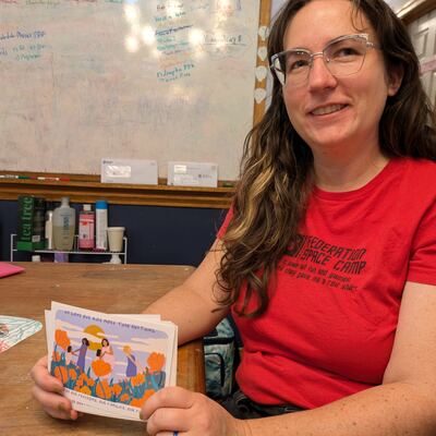 A MomsRising volunteer with handwritten postcards