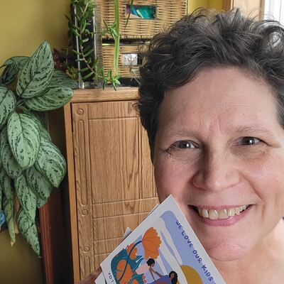 A MomsRising volunteer with handwritten postcards