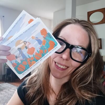 A MomsRising volunteer with handwritten postcards