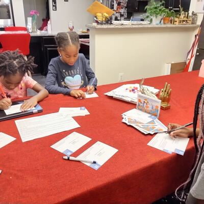 A MomsRising volunteer with handwritten postcards