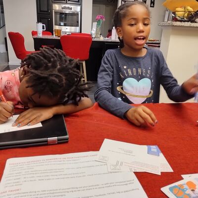 A MomsRising volunteer with handwritten postcards