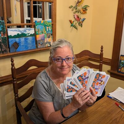A MomsRising volunteer with handwritten postcards