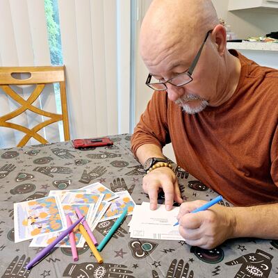 A MomsRising volunteer with handwritten postcards