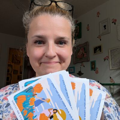 A MomsRising volunteer with handwritten postcards