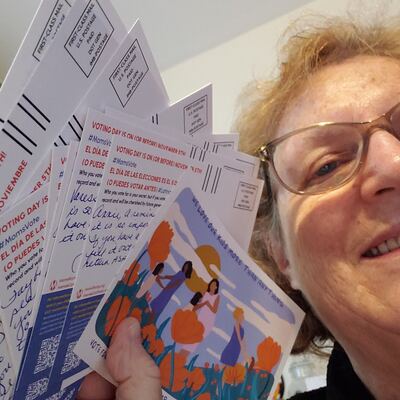 A MomsRising volunteer with handwritten postcards