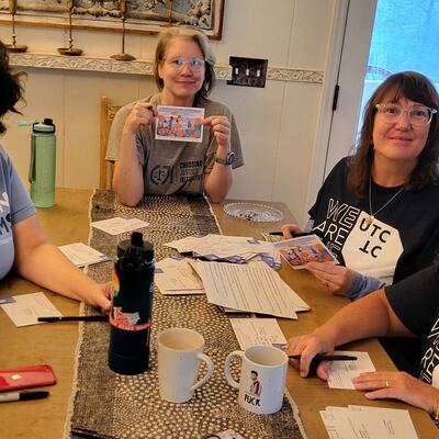 A MomsRising volunteer with handwritten postcards