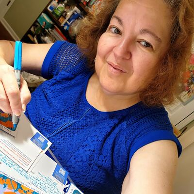 A MomsRising volunteer with handwritten postcards