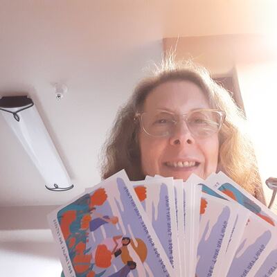 A MomsRising volunteer with handwritten postcards