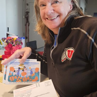 A MomsRising volunteer with handwritten postcards
