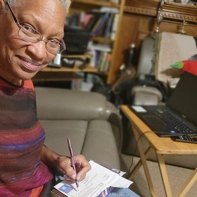 A MomsRising volunteer with handwritten postcards