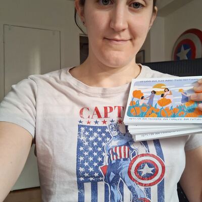 A MomsRising volunteer with handwritten postcards