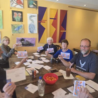 A MomsRising volunteer with handwritten postcards
